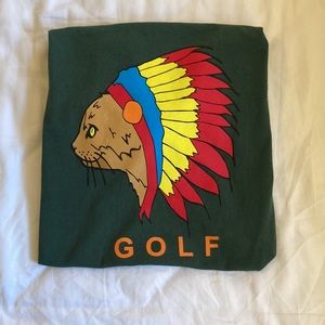 Green GOLF WANG tshirt with feline in headdress graphic and orange GOLF wording